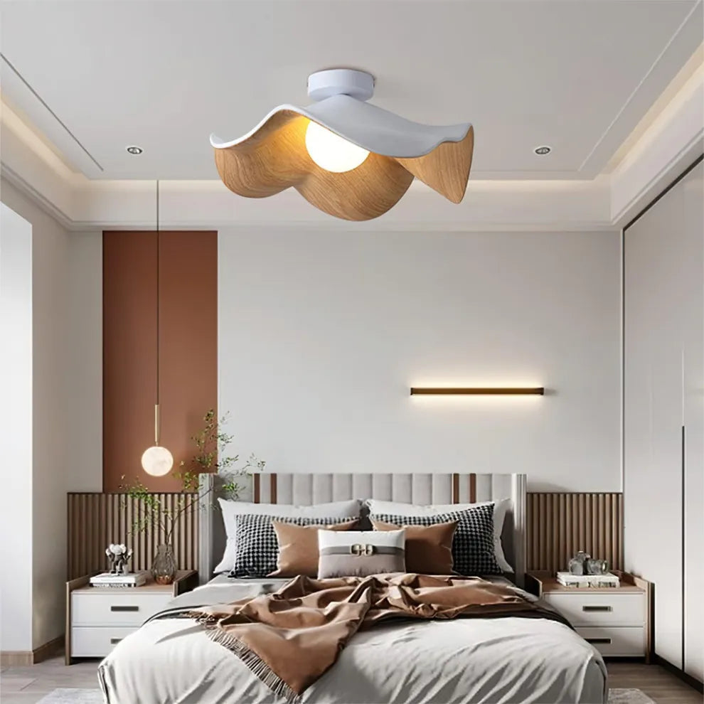 Modern bedroom with a stylish ceiling light fixture.